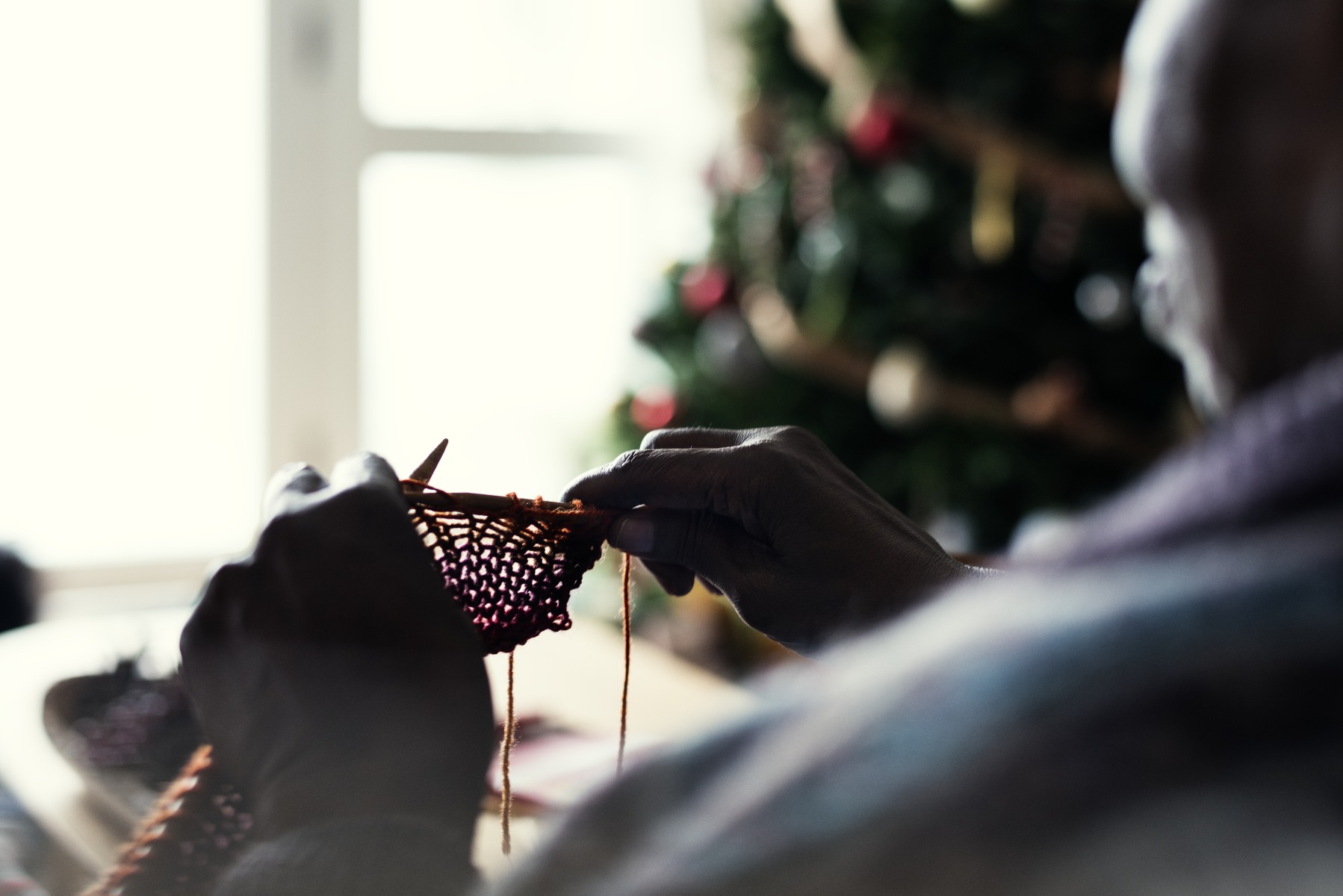 knitting by christmas tree
