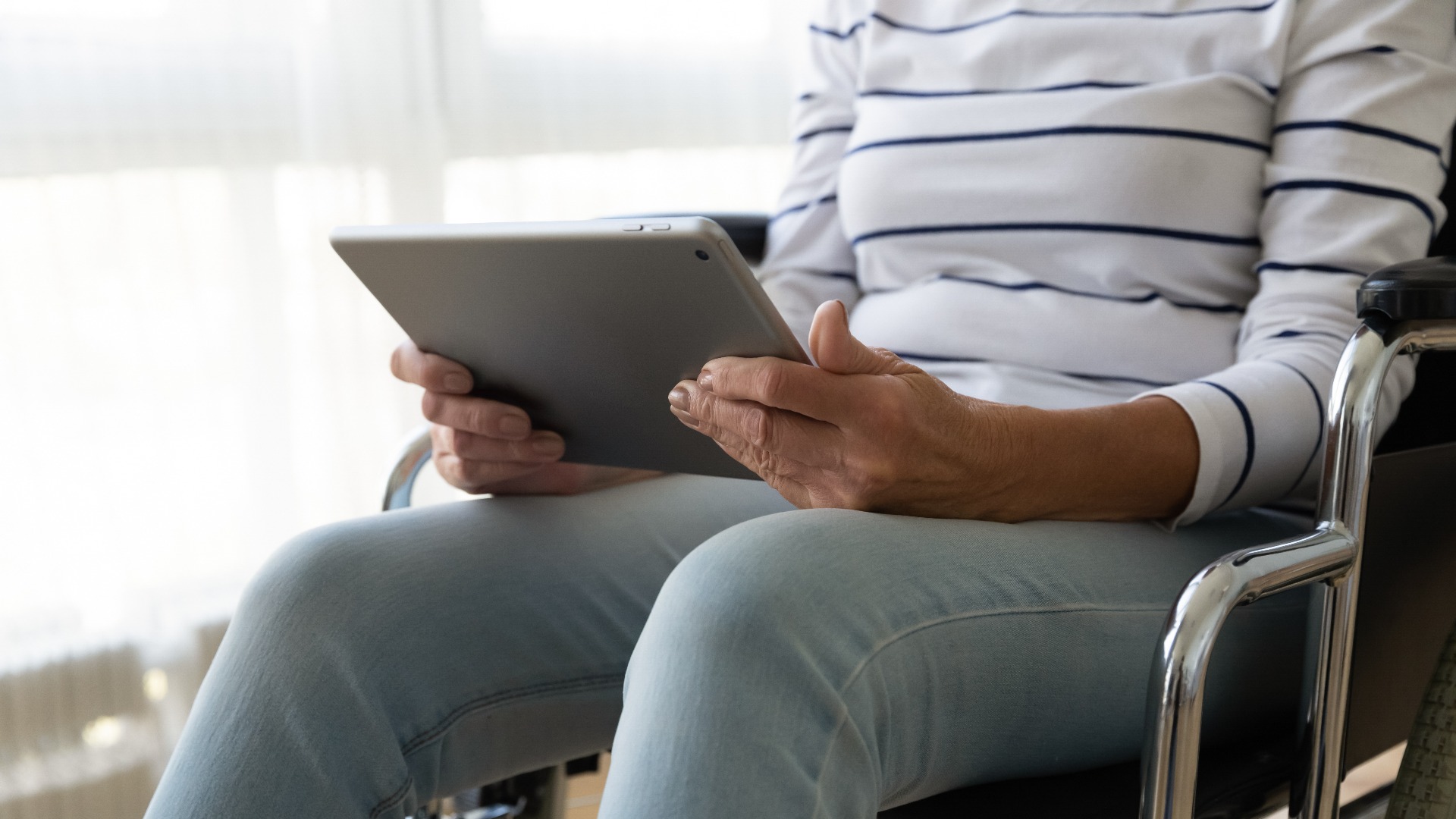 disabled woman watches tablet